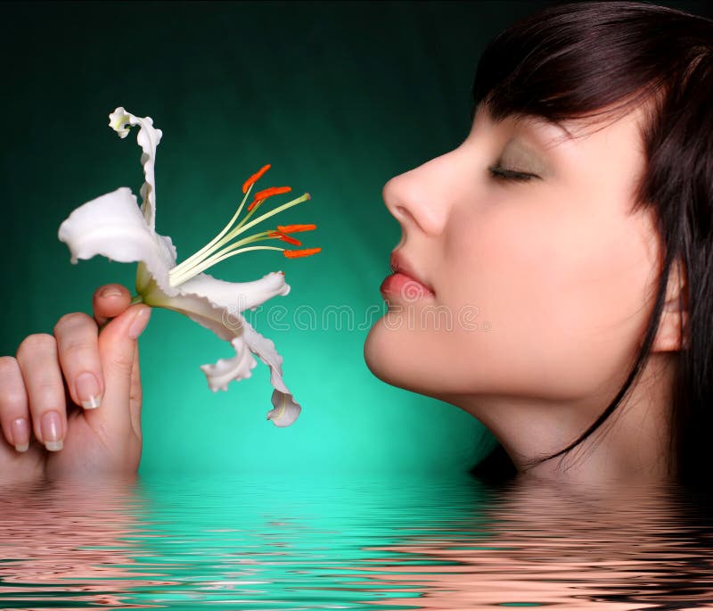 Brunette with white lily flowers in water