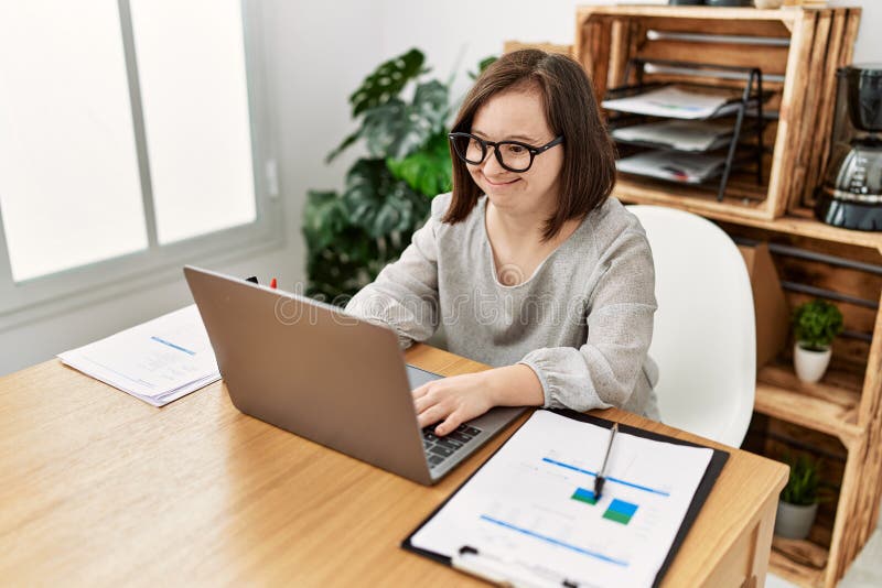 Woman with Down Syndrome Working Using Laptop at Business