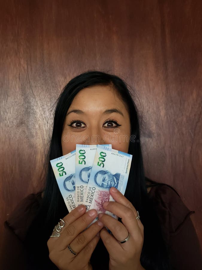 brunette woman holding mexican banknotes and expressing happiness stock photography brunette woman holding mexican banknotes and expressing happiness stock photography