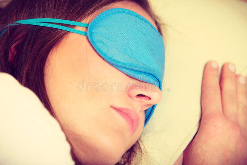 Brunette woman sleeping in blue eye sleep mask royalty free stock image Brunette woman sleeping in blue eye sleep mask royalty free stock image