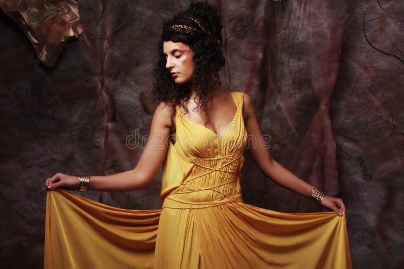 Brunette woman wearing yellow evening dress stock photo Brunette woman wearing yellow evening dress stock photo