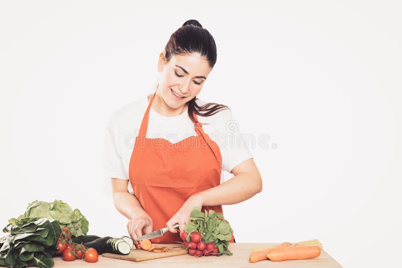 Brunette young woman Cutting Vegetables stock image