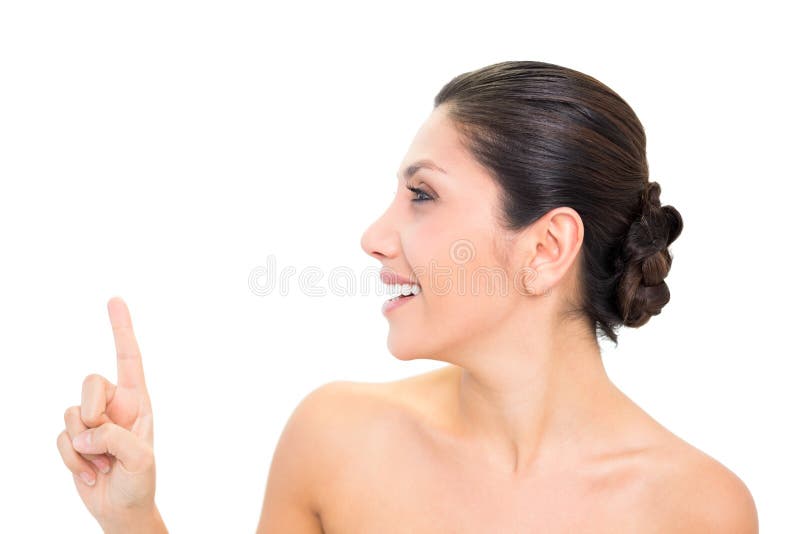 Brunette χαμόγελου που δείχνει επάνω με ένα χέρι με το κεφάλι που γυρίζουν στοκ εικόνα με δικαίωμα ελεύθερης χρήσης Brunette χαμόγελου που δείχνει επάνω με ένα χέρι με το κεφάλι που γυρίζουν στοκ εικόνα με δικαίωμα ελεύθερης χρήσης