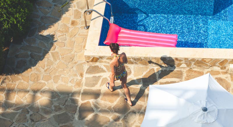 Brunettefrau nahe Swimmingpool am sonnigen Tag stockfoto Brunettefrau nahe Swimmingpool am sonnigen Tag stockfoto