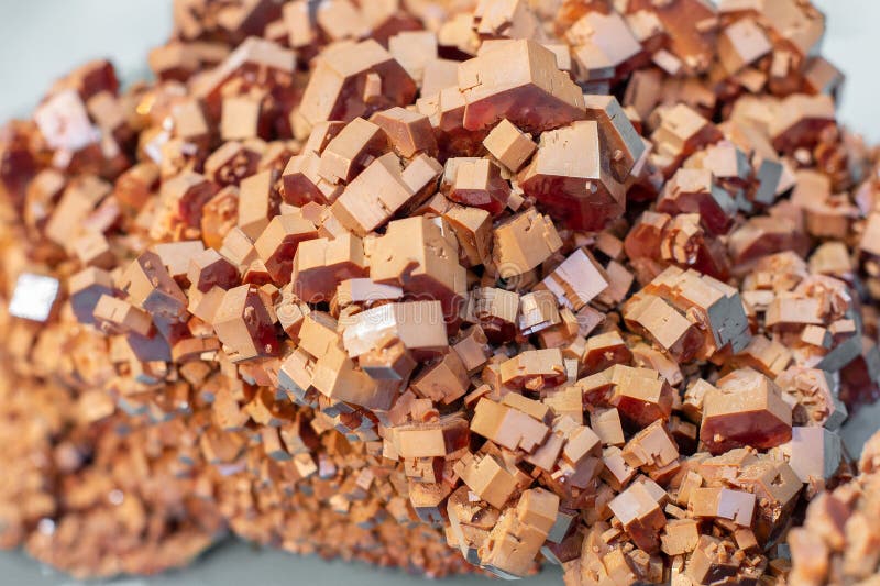 Brownish-red vanadinite hexagonal crystals piled up around. Natural mineral cluster. Brownish-red vanadinite hexagonal crystals piled up around. Natural mineral cluster.