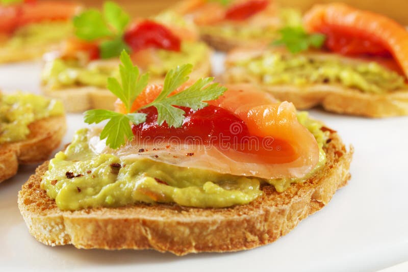 Bruschetta avec le guacamole, saumon fumé photos libres de droits Bruschetta avec le guacamole, saumon fumé photos libres de droits