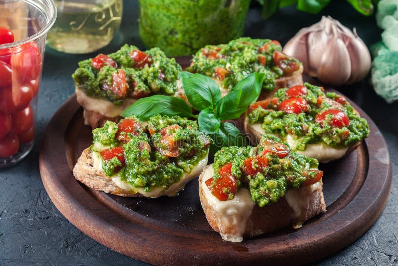 Bruschetta with Fresh Pesto, Mozzarella and Cherry Tomatoes on C Stock