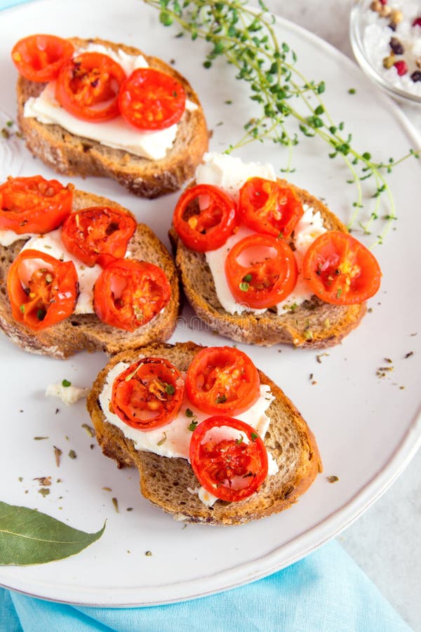 Bruschetta with Roasted Tomatoes Stock Photo - Image of food, herb