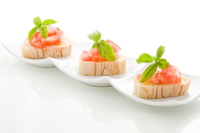 Bruschetta with tomatoes and basil isolated