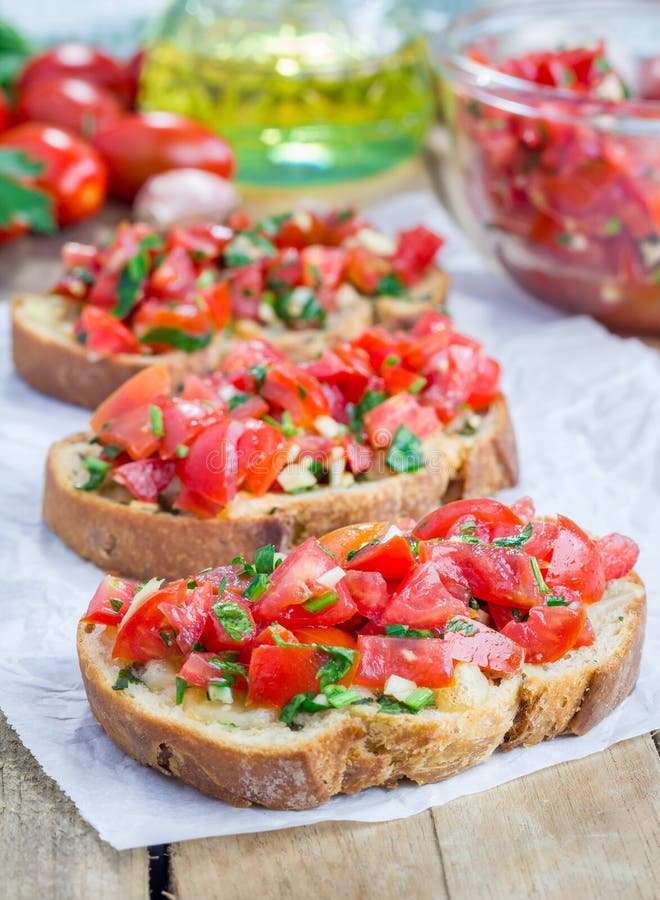 Bruschetta with Tomatoes, Herbs and Oil on Garlic Cheese Bread Stock
