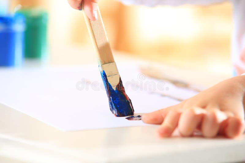 Brush in kid hand closeup stock photo. Image of painting - 95540174