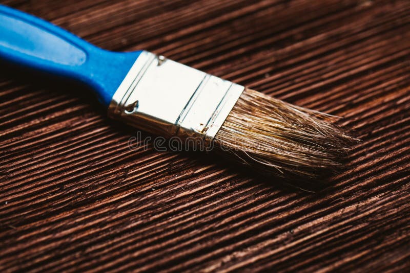 Brush to paint on a dark wooden background