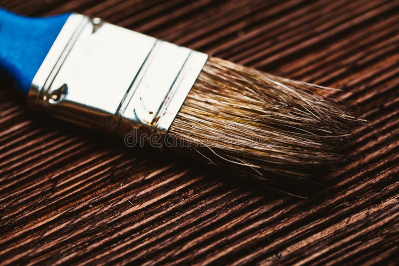 Brush to paint on a dark wooden background