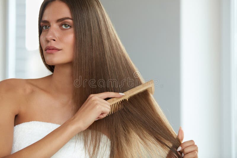 Brushing Hair. Portrait Of Young Woman Brushing Straight Natural Hair With Comb. Closeup Of Girl Combing Beautiful Long Healthy Hair With Hairbrush. Hair Care And Beauty Concept. High Resolution. Brushing Hair. Portrait Of Young Woman Brushing Straight Natural Hair With Comb. Closeup Of Girl Combing Beautiful Long Healthy Hair With Hairbrush. Hair Care And Beauty Concept. High Resolution