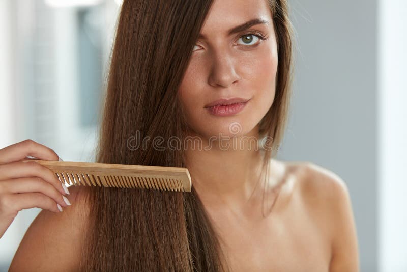 Brushing Hair. Portrait Of Young Woman Brushing Straight Natural Hair With Comb. Closeup Of Girl Combing Beautiful Long Healthy Hair With Hairbrush. Hair Care And Beauty Concept. High Resolution. Brushing Hair. Portrait Of Young Woman Brushing Straight Natural Hair With Comb. Closeup Of Girl Combing Beautiful Long Healthy Hair With Hairbrush. Hair Care And Beauty Concept. High Resolution