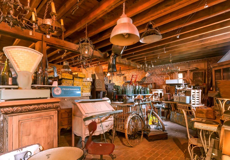 Vintage room with retro furniture, decoration, used rustic utensils in historical home attic