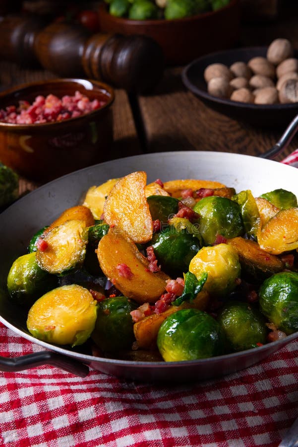 Brussels Sprouts Potato Pan with Bacon in Rustic Style Stock Image