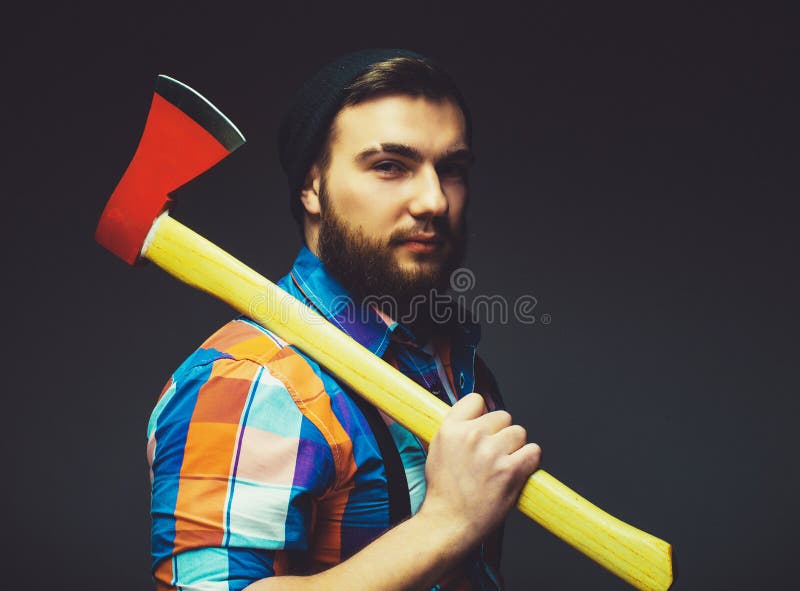 Brutal bearded male holds an axe on his shoulder. royalty free stock photo Brutal bearded male holds an axe on his shoulder. royalty free stock photo