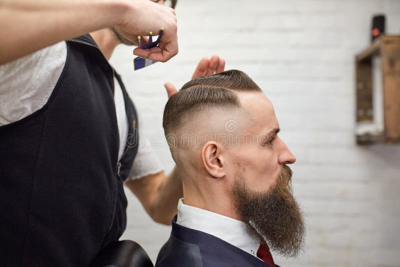 Brutal Guy in Modern Barber Shop. Hairdresser Makes Hairstyle a Man with a  Long Beard. Master Hairdresser Does Hairstyle Stock Image - Image of  hipster, haircutter: 146397865