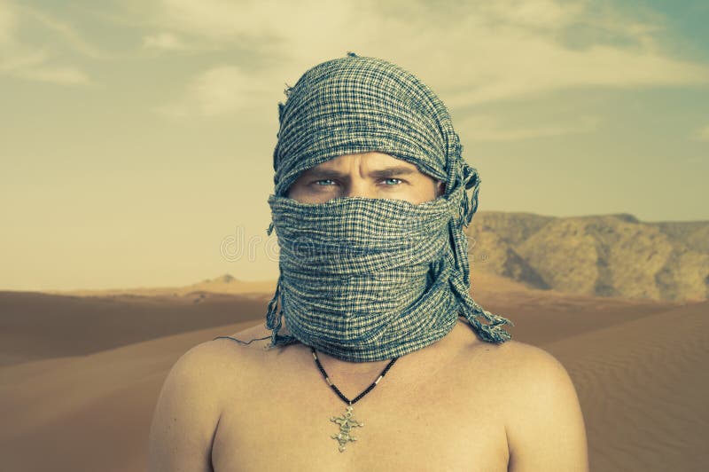 Brutal man in desert stock images