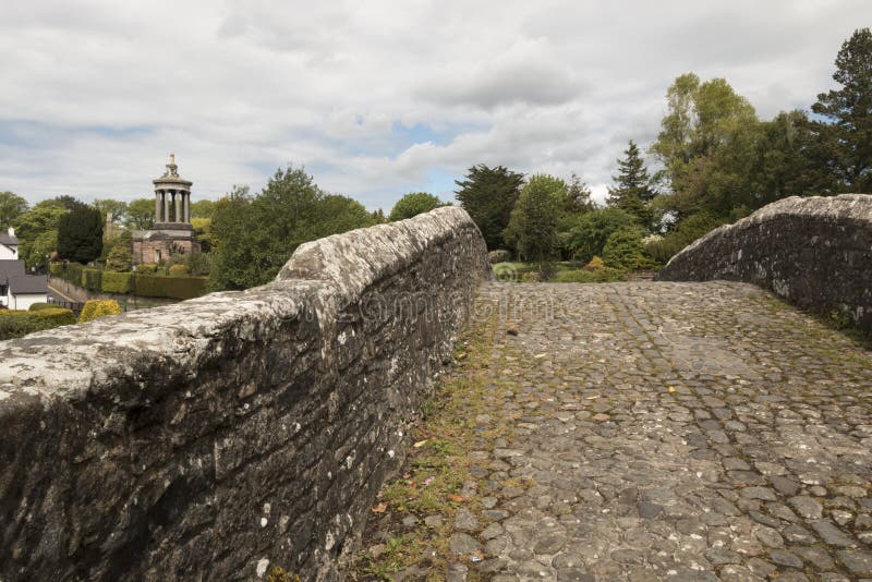 The bridge is thought to have been built in the early fifteenth century. The line of the cobbles in the roadway is cranked, due to the belief that this pattern would stop witches from crossing. It is used as the setting for the final verse of the Robert Burns's poem Tam o' Shanter. The bridge is thought to have been built in the early fifteenth century. The line of the cobbles in the roadway is cranked, due to the belief that this pattern would stop witches from crossing. It is used as the setting for the final verse of the Robert Burns's poem Tam o' Shanter.