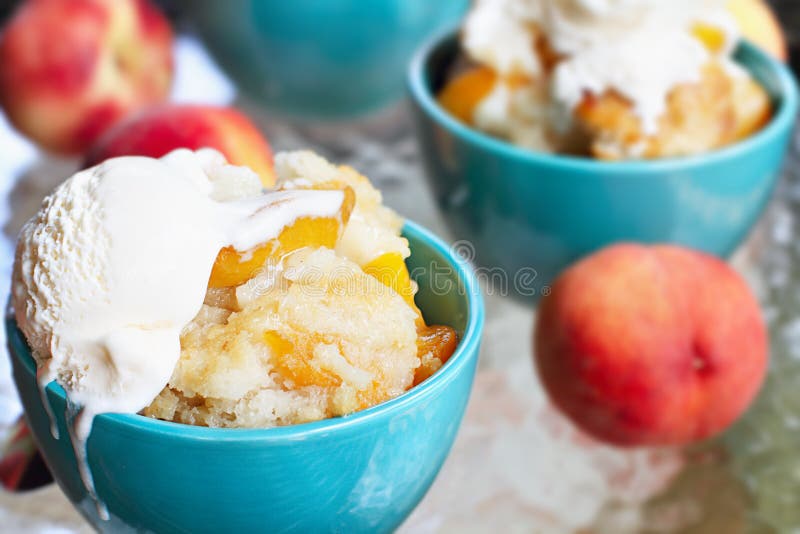 Fresh peach cobbler served with vanilla ice cream. Fresh peach cobbler served with vanilla ice cream.