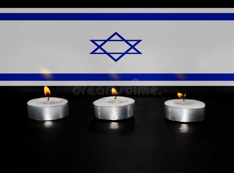 Burning candles with Semi Transparent Flag of Israel background. Photo for Israel Memorial Day, Holocaust Remembrance Day or Memorial Day for Fallen Soldiers and Victims of Hostile Acts. Burning candles with Semi Transparent Flag of Israel background. Photo for Israel Memorial Day, Holocaust Remembrance Day or Memorial Day for Fallen Soldiers and Victims of Hostile Acts