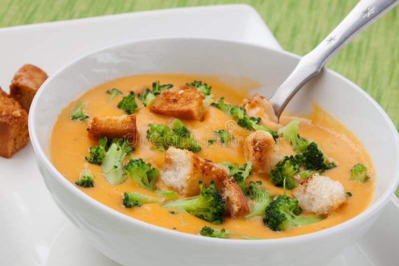 Close up of hot delicious broccoli - cheddar cheese soup with garlic croutons. Close up of hot delicious broccoli - cheddar cheese soup with garlic croutons.