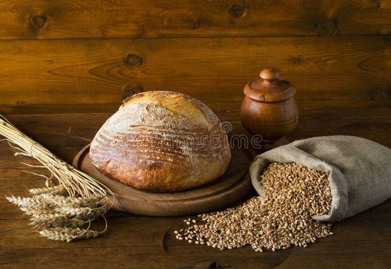 Bröd och vete på bordet arkivfoton
