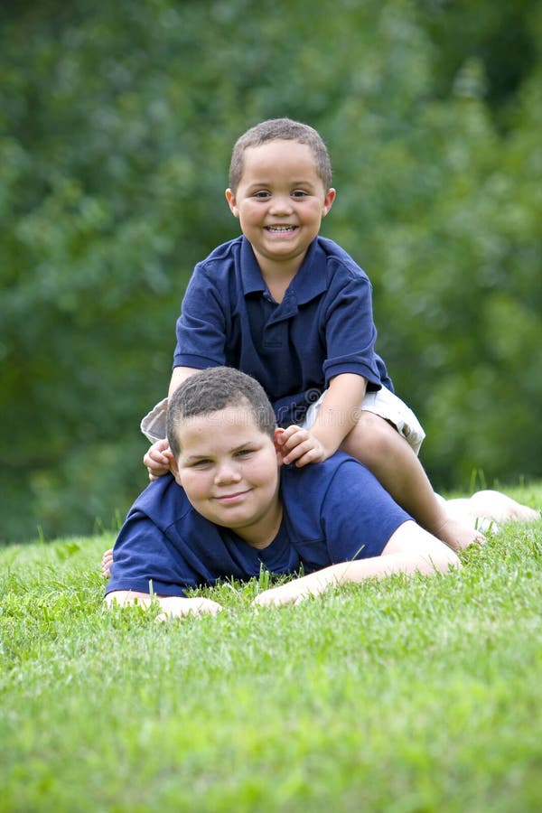 Two brothers playing on fresh green grass. Two brothers playing on fresh green grass