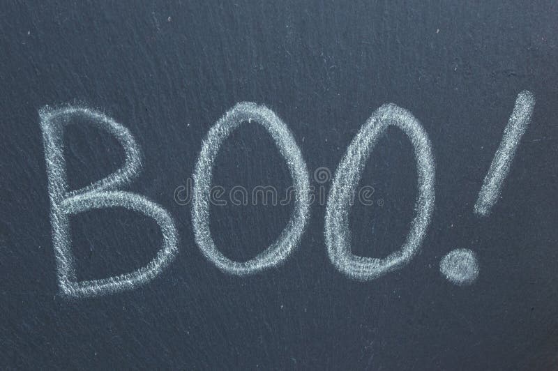 Boo! Chalk text written on slate. Ghostly Halloween word of shock and surprise. Boo! Chalk text written on slate. Ghostly Halloween word of shock and surprise.