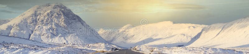 Buachaille Etive Mor mountain and empty road covered in snow during winter