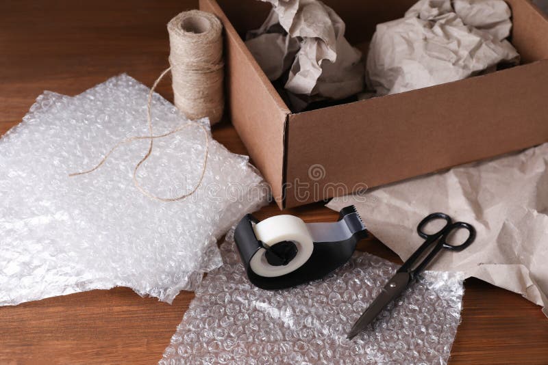 Cardboard Box Packed In Bubble Wrap Scissors And Adhesive Tape On White  Background Stock Photo - Download Image Now - iStock