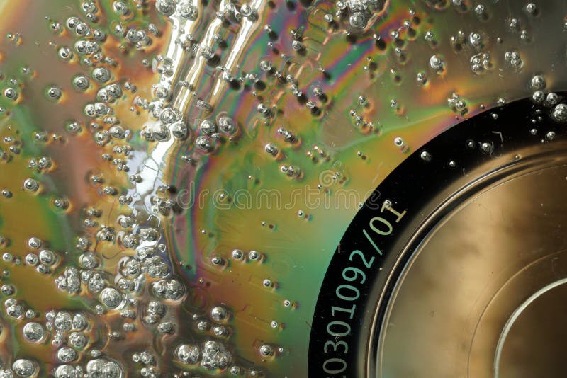 Bubbles on damaged CD surface. Macro abstract textured background