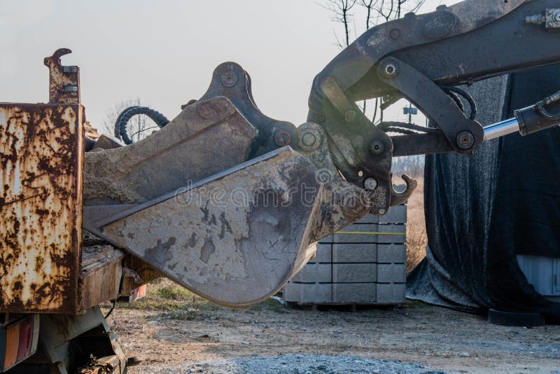 Bucket Attached To Backhoe Arm Resting on Truck Stock Image Image of