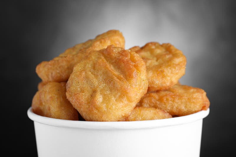 Bucket with Delicious Chicken Nuggets on Background, Top View. Space