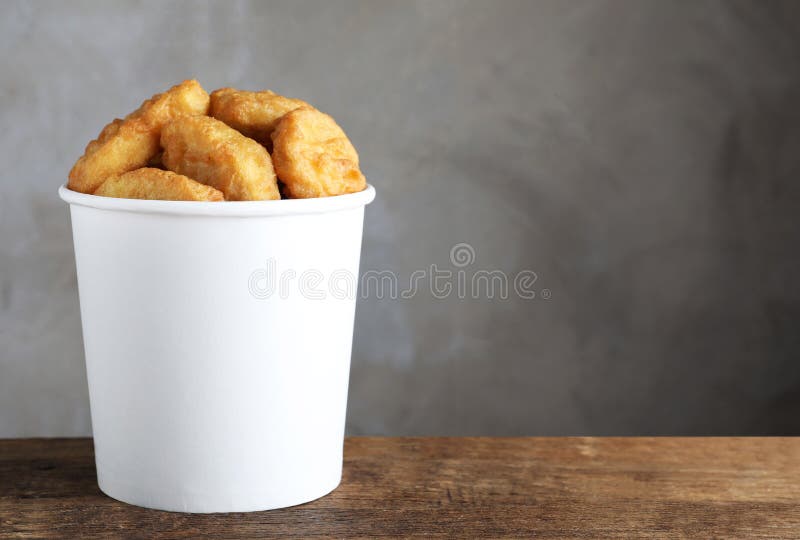 Bucket with Delicious Chicken Nuggets on Background, Top View. Space