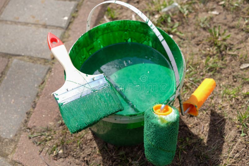 A Bucket of Green Paint and a Paintbrush Stock Image Image of concept