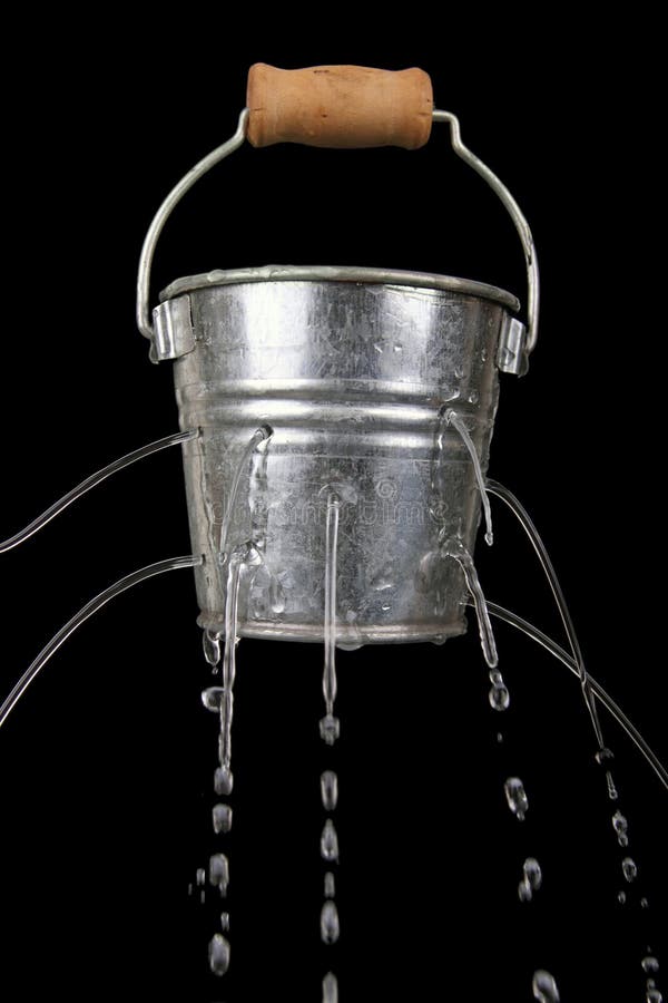 Tin bucket with holes and water coming out of it