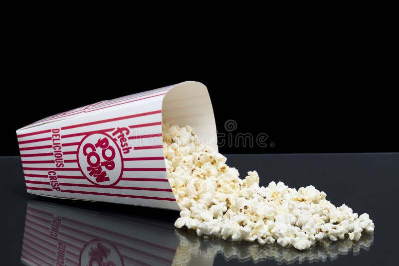 Bucket of spilled popcorn stock photo