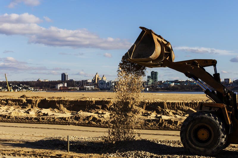 Bucket from the Tractor with Sand on the Construction Site Stock Photo