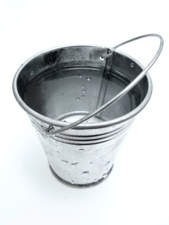 The metallic bucket full of water. The metallic bucket full of water