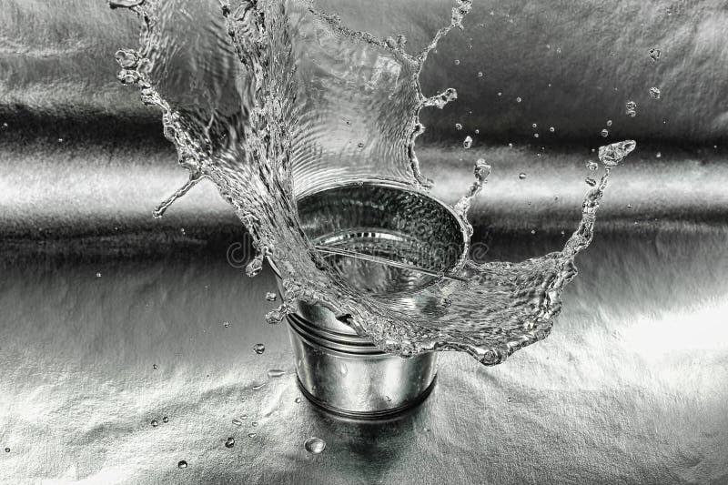 High speed image of tin bucket with water hitting the ground. High speed image of tin bucket with water hitting the ground