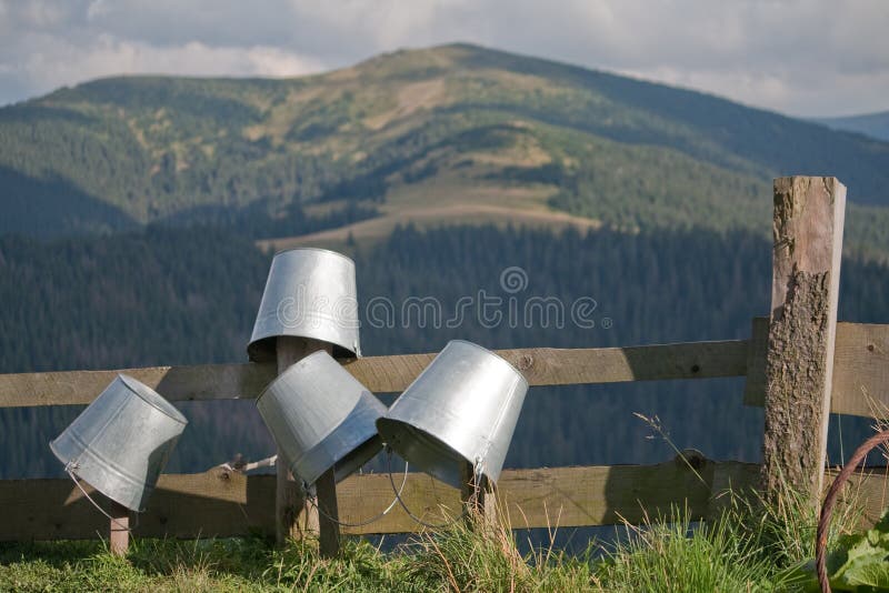Buckets for milk dried on the fence. Mountain milk stock images, royalty-free photos and pictures