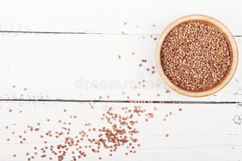 Buckwheat groats on wooden stock image. Image of cereal 87357985