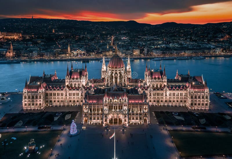 Budapest, Hungary - Aerial panoramic view of the beautiful illuminated Hungarian Parliament building at dusk with Christmas tree