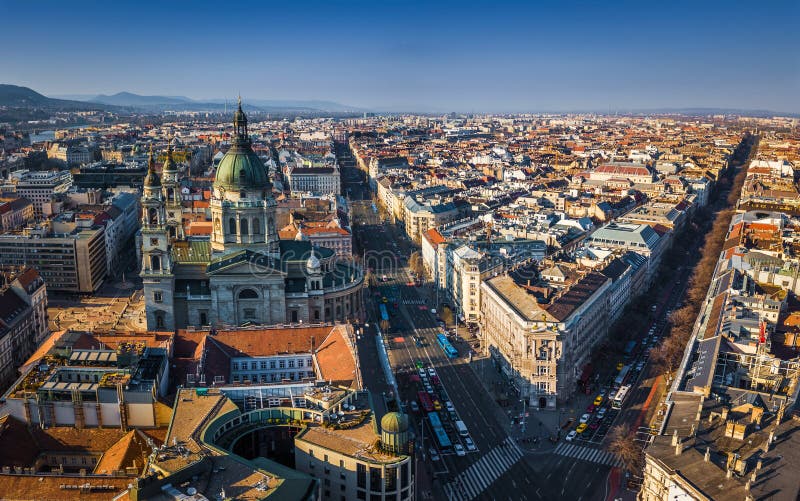 Budapest, Hungary - Aerial view of St.Stephen`s basilica with Andrassy street and Bajcsy Zsilinszky street at sunset with clear blue sky. Budapest, Hungary - Aerial view of St.Stephen`s basilica with Andrassy street and Bajcsy Zsilinszky street at sunset with clear blue sky