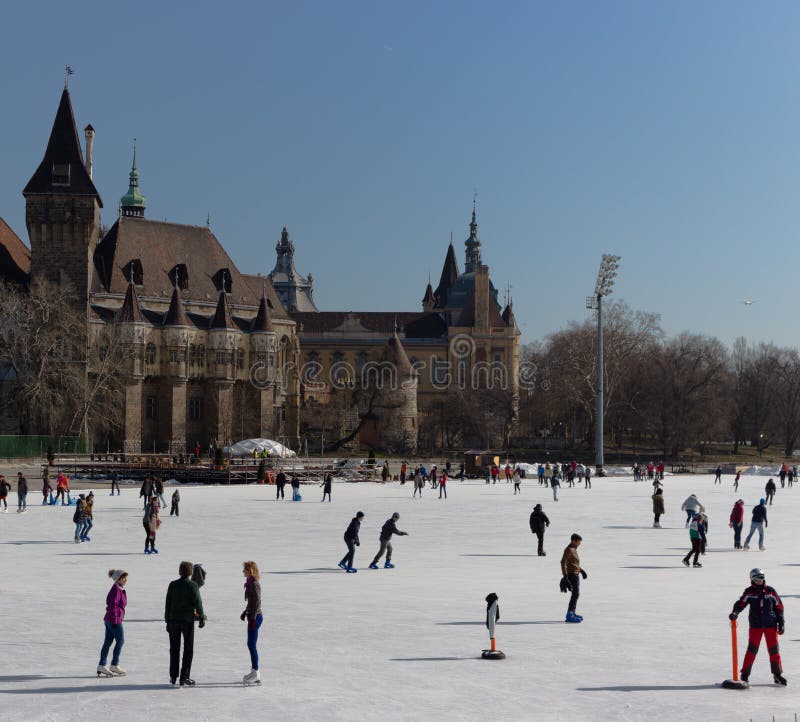 Budapest, Hungary - 02/19/2018: ice rink with people against old castle in Varoshelighet park. Winter sport and fun. royalty free stock photography Budapest, Hungary - 02/19/2018: ice rink with people against old castle in Varoshelighet park. Winter sport and fun. royalty free stock photography
