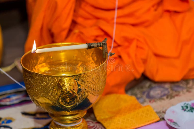 Buddha monk hold candlestick above holy water bowl. religion ceremony. Buddhist holy water. image for copy space. royalty free stock image Buddha monk hold candlestick above holy water bowl. religion ceremony. Buddhist holy water. image for copy space. royalty free stock image