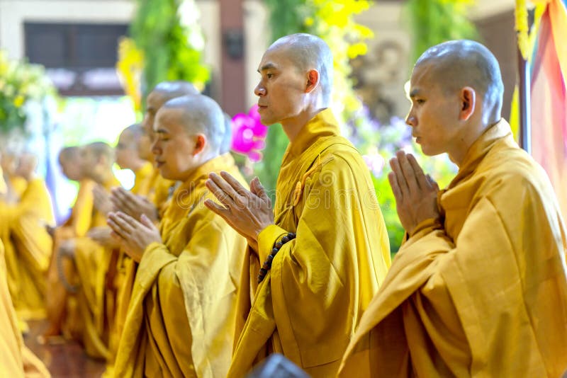 Ho Chi Minh City, Vietnam - May 29, 2018: Buddhist monk praying Buddha in Buddha`s birthday celebrations being held in temple morning as a ritual of traditional culture in Ho Chi Minh city, Vietnam